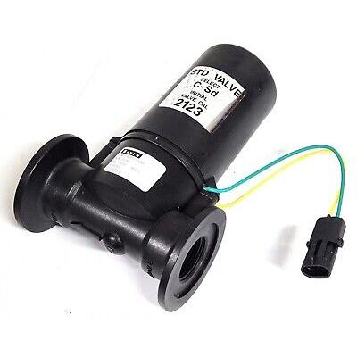 Black cylindrical STD valve with flanged ports, white identification labels, and a green and yellow wire with a connector.