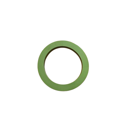 Flat green circular gasket made of durable industrial material on a white background.
