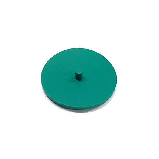 Small green circular plastic component with a centered vertical peg, isolated on a white background.