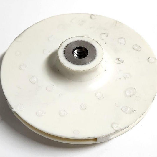 White Valox pump impeller with a circular plastic disc design and a threaded metal center hub.