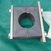 1-inch Behringer clamp with a black ribbed rubber block secured between two metal plates and bolts on a green background.