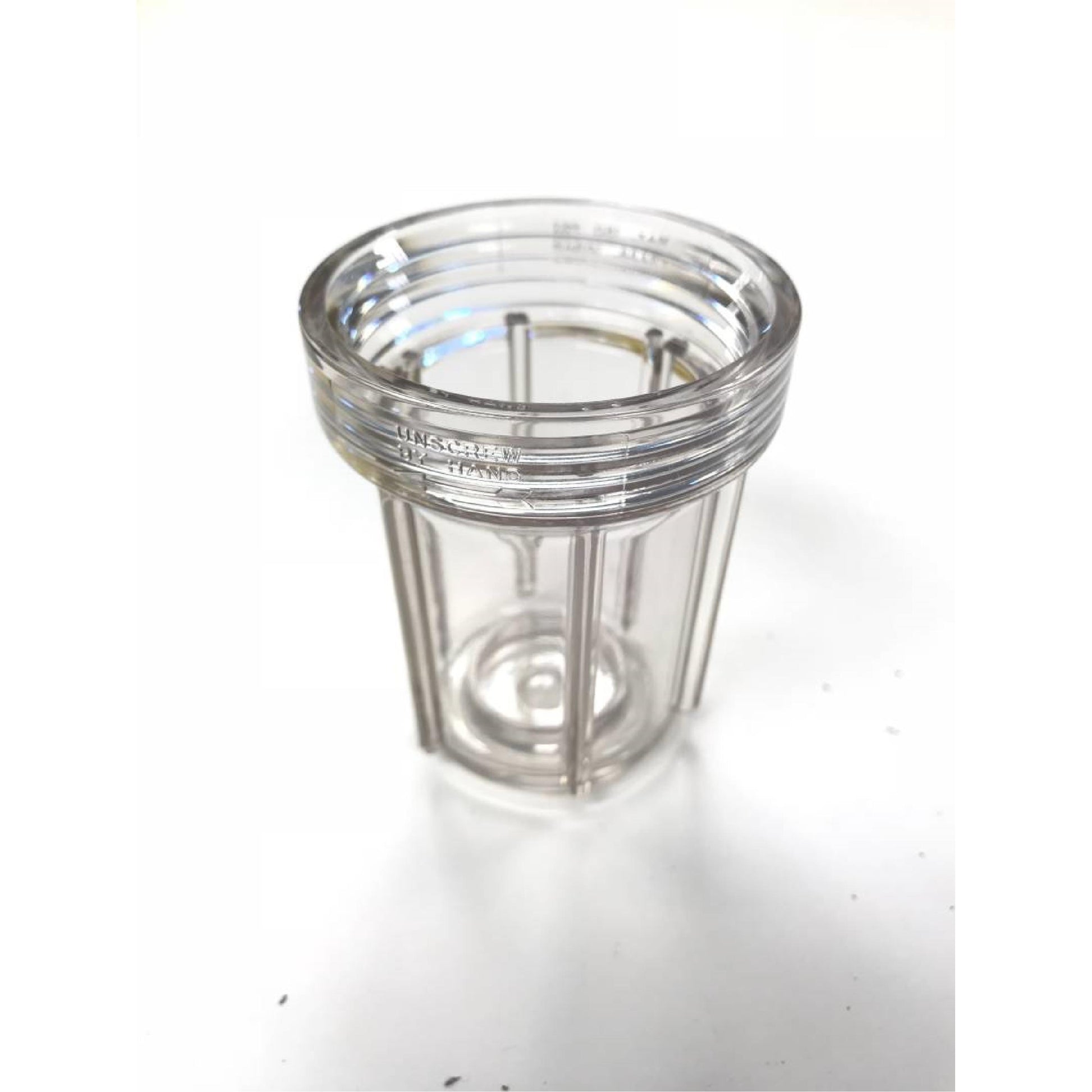 Clear plastic CP23172-NY water filter housing with threaded rim and vertical structural ribs on a white background.
