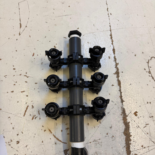 SCESideIce spray manifold with six black Raven valve nozzles mounted on a grey PVC pipe section.