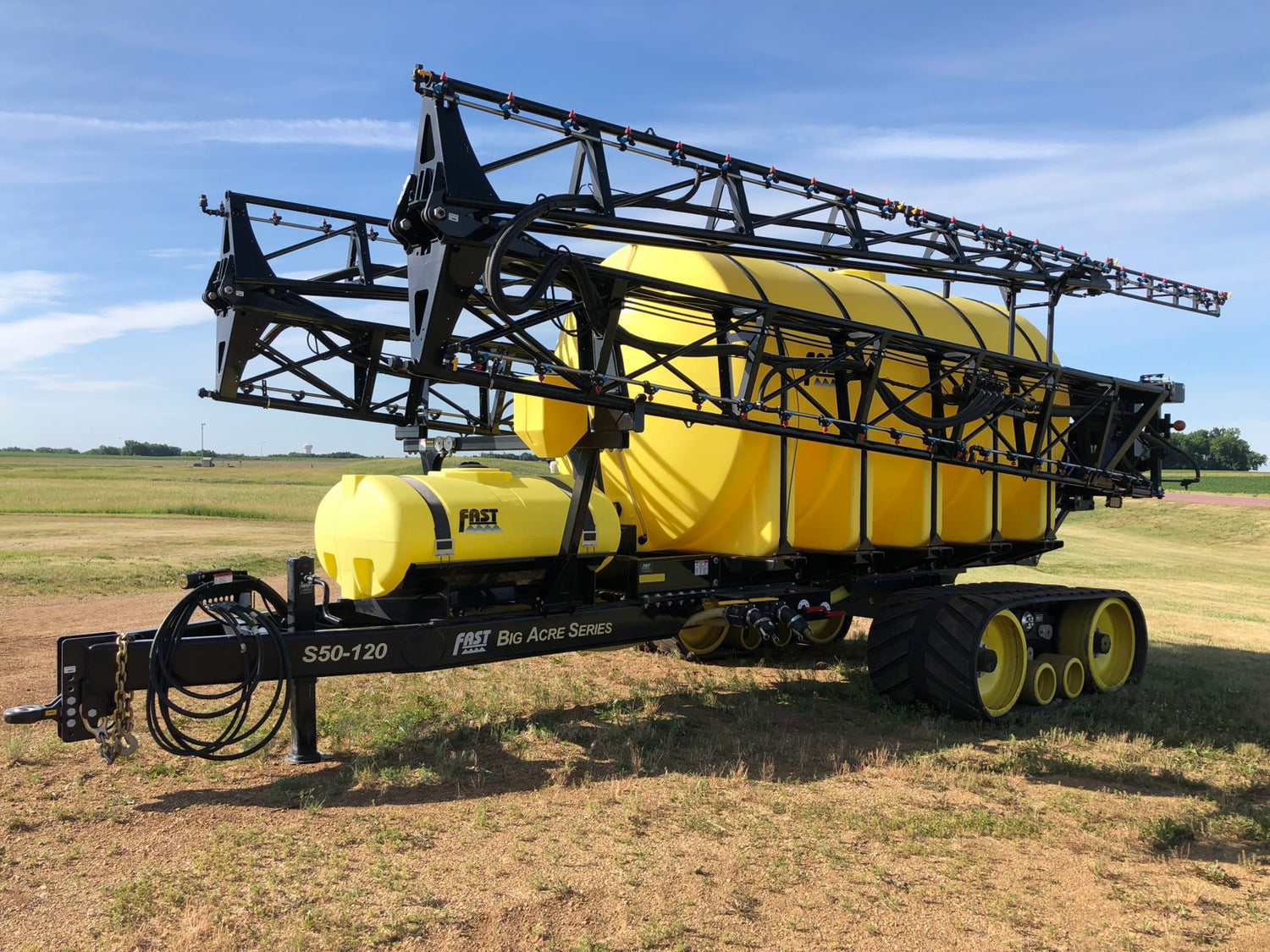 FAST Big Acre Series S50-120 pull-type sprayer on CAMSO tracks with booms folded